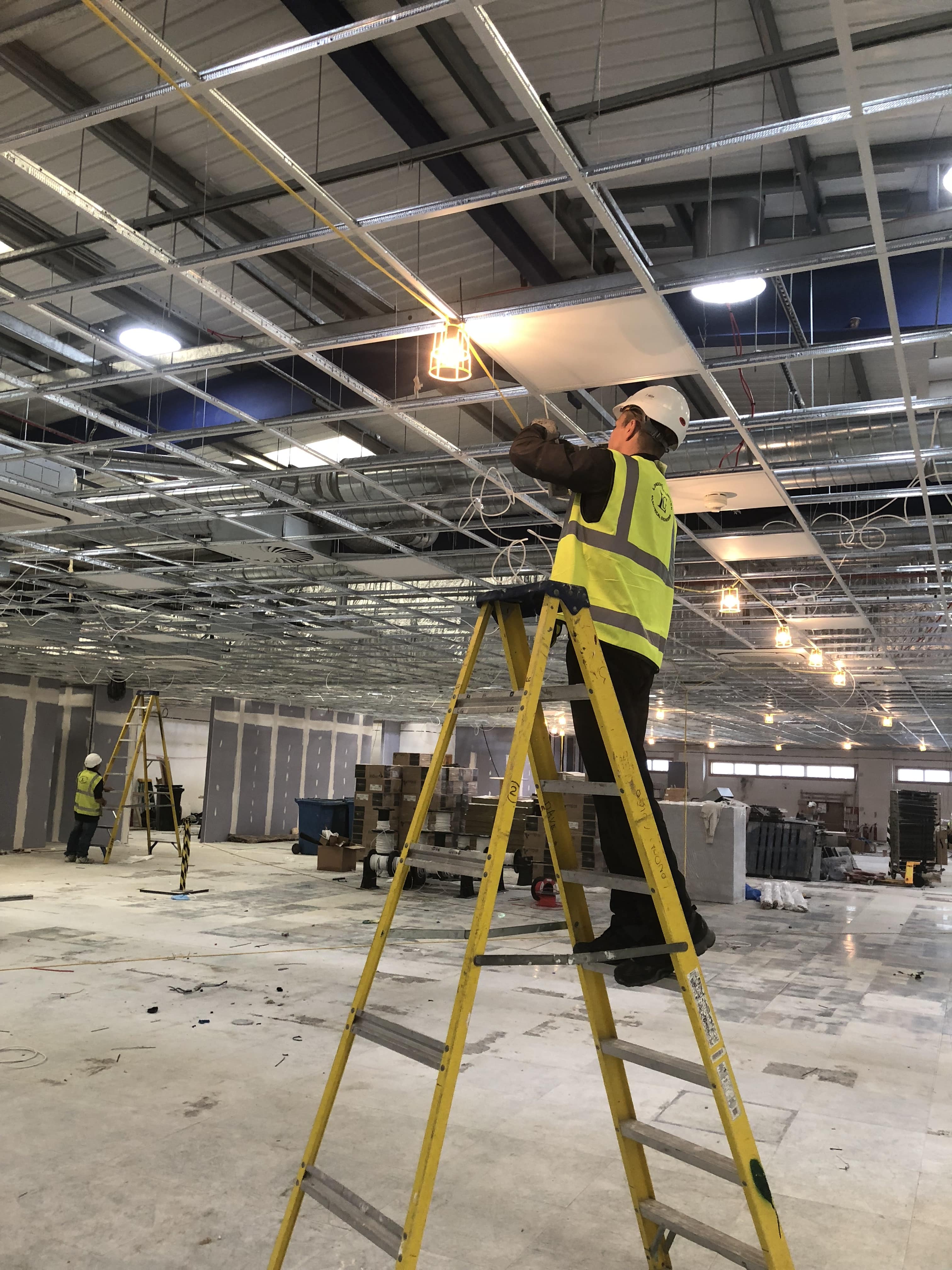 Lights being fitted into an office ceiling