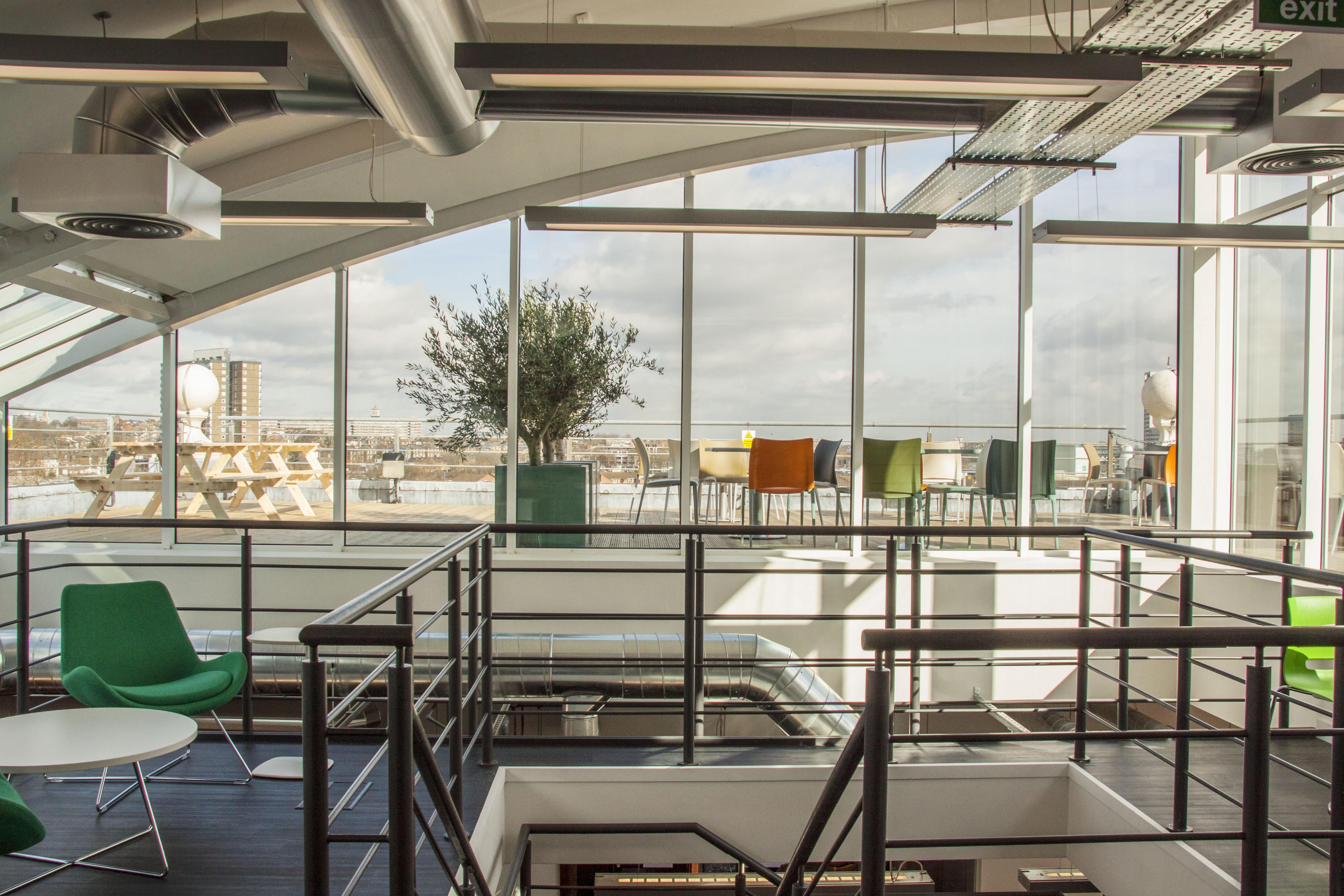 Office rooftop cafe area with bright colourful chairs